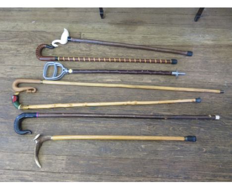 Six handmade walking sticks, including one with swan form handle, another with pheasant head form handle and horn handled sti