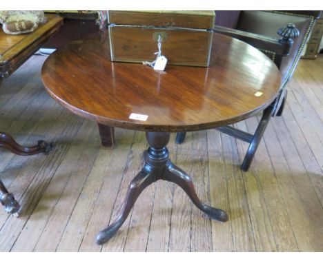 A George III mahogany snaptop tripod table, the circular top on a baluster stem and cabriole legs, 73cm diameter