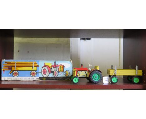 Konrad Dressler: clockwork lithographed tinplate Tractor with Trailer, with key in original box, 33cm