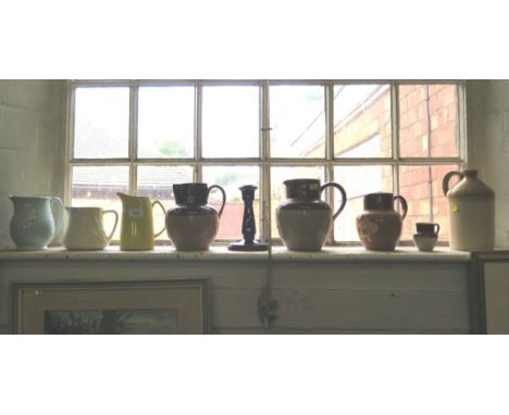 A Denby Pottery blue glaze candlestick, a Cadburys stoneware jug and other stoneware and ceramic jugs