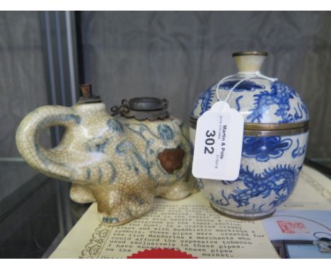 A Chinese blue and white ceramic pipe in the form of an elephant 14cm long with certificate from House of Choy Sdn.Bhd. and a