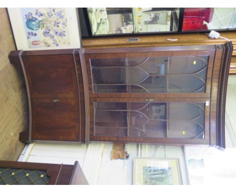 A mahogany reproduction concave corner display cabinet, the lancet arched glazed doors over cupboard doors on bracket feet, 9