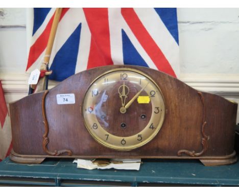 A 1920s oak mantel clock, with silvered dial, the three train movement striking on a gong, 52cm wide