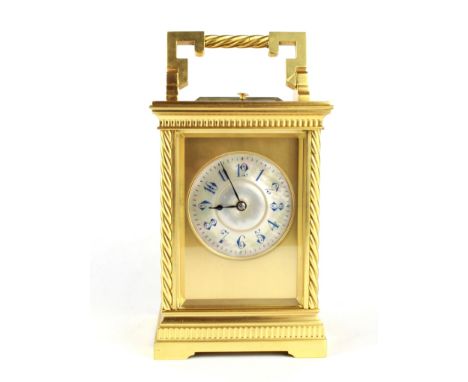 An Edwardian French gilt brass carriage clock with spiral twist columns and mother of pearl dial, the repeating mechanism str