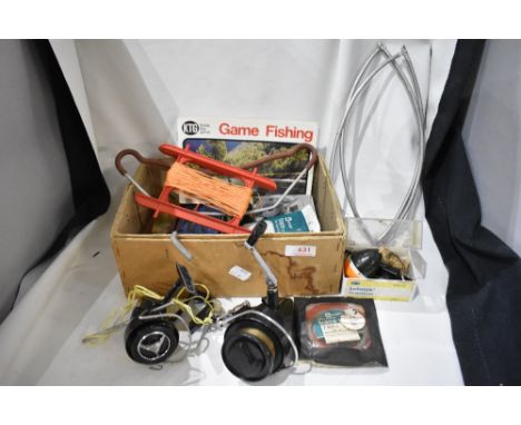 A small box of mixed vintage fishing tackle including hooks, weights and two spinning reels one Intrepid and a Galion