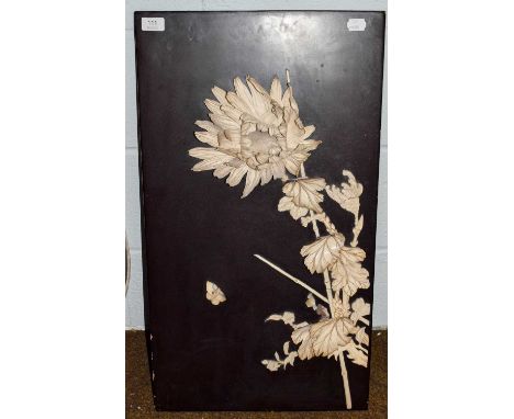 A Japanese Meiji period panel applied with carved ivory sections in the form of blossom and a butterfly, 42 cm by 76 cm