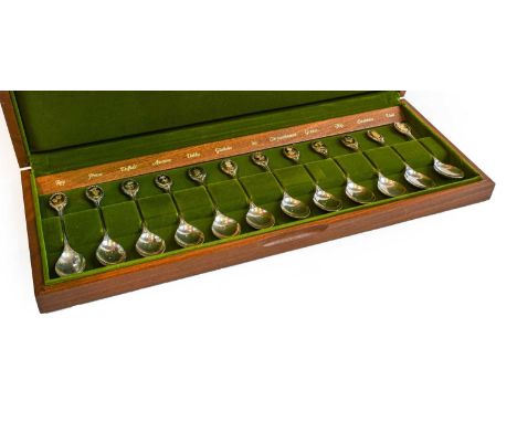 A cased set of twelve Elizabeth II parcel-gilt silver spoons, by John Pinches Ltd., Sheffield, 1974, each with a terminal app