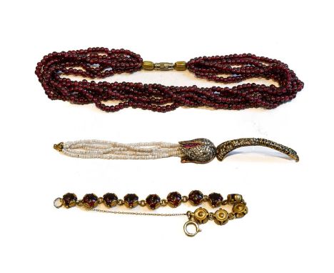 A garnet five strand bead necklace, length 38cm; a garnet bracelet, length 17.5cm; and a paste bangle (a.f.)