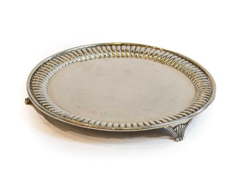 A Victorian Silver Salver, by Martin and Hall, London, 1890, circular and on three fluted panel feet, with fluted rim, 21cm d