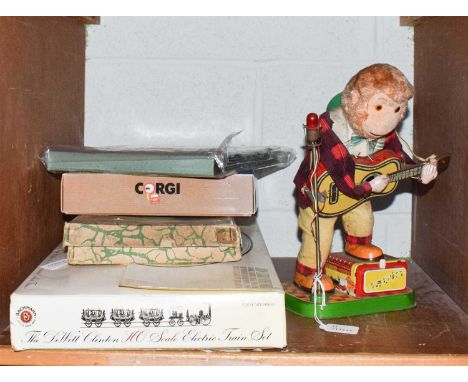 A tin plate guitar playing monkey, a Branko mechanical acrobat Japenese boxed toy, two boxed Corgi post vans, a boxed Bachman