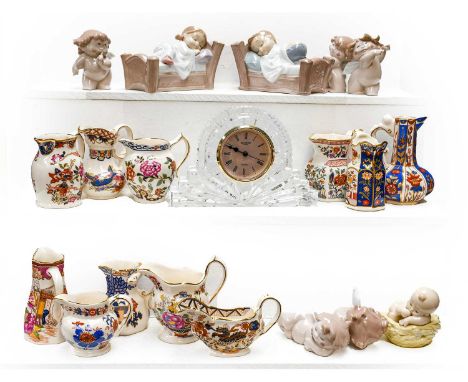 A Waterford crystal mantel clock, twelve Masons miniature jugs, and eight Nao figures