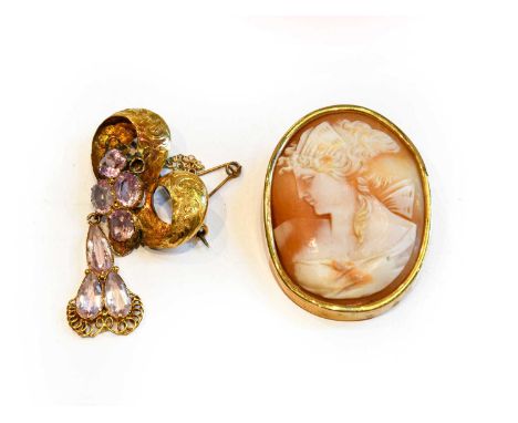 An amethyst bow brooch, unmarked, drop length 4.9cm; and a cameo brooch/pendant, measures 5.5cm by 3.3cmCondition report: Ame