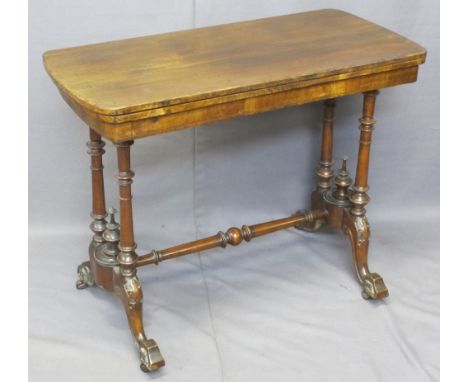 VICTORIAN WALNUT FOLDOVER CARD TABLE on turned columns and four splayed feet with cross stretcher, 74cms H, 91cms W, 44cms D