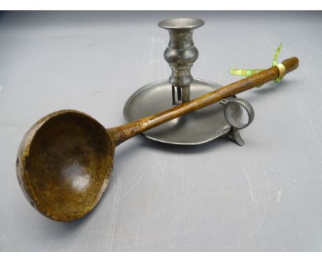 POLISHED WOODEN LADLE (PROBABLY WALNUT) and a vintage pewter chamber stick, 39cms L and 11.5cms H respective measurements