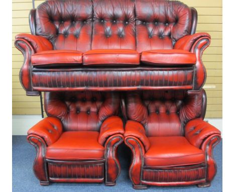 VINTAGE BUTTON BACK RED LEATHER EFFECT THREE PIECE SUITE of three seater settee and a pair of armchairs (one a recliner), all