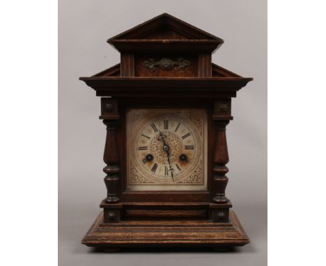 A German carved oak Junghans mantel clock with twin train movement, chiming on a coiled gong.Condition report intended as a g