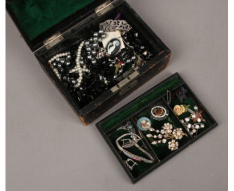 A jewellery box and contents of costume jewellery to include enamel badges, brooches, silver bracelets etc.