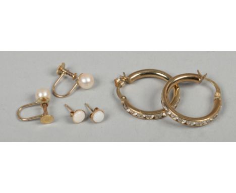 Three pairs of 9ct gold earrings including opal and pearl set examples.