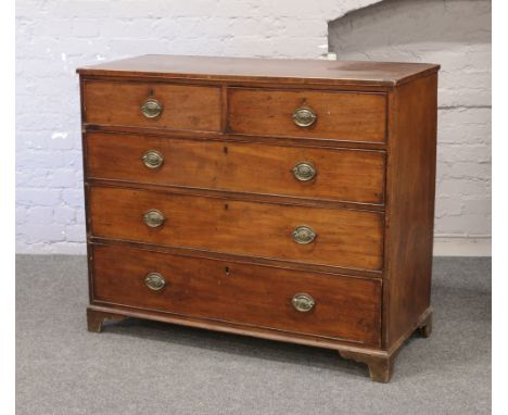 A Georgian mahogany chest of two over three graduated drawers raised on bracket feet.
