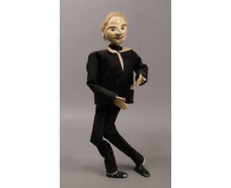 A plaster puppet in evening dress attire.