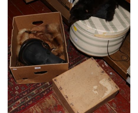 A box of fur stoles and hats to include horse riding helmet etc.