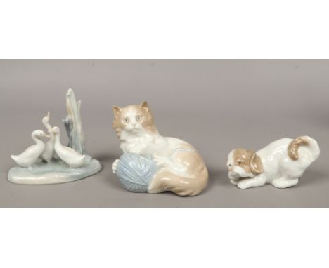 Three Nao ceramic figures of animals; dog, cat and ducks.