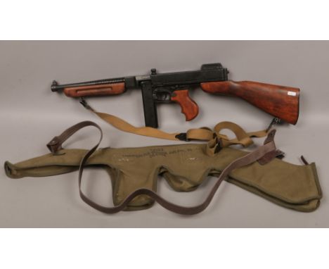 A Denix Thompson replica .45 sub machine gun model of 1928 No. 2763 along with a 30 round magazine, carry strap and canvas / 