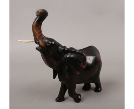 A carved wooden model of an African elephant.Condition report intended as a guide only.With damage.