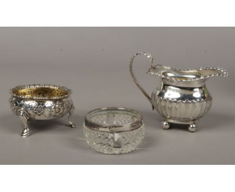 A George III silver salt cellar, assayed London 1762, along with a 20th century silver cream jug by William Hutton &amp; Sons