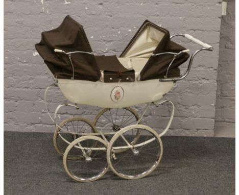 A vintage Silver Cross dolls pram.