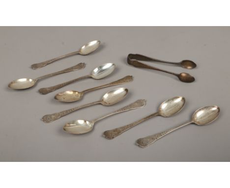 A set of eight monogrammed George V silver teaspoons assayed Sheffield 1926, along with a pair of similar silver sugar nips.