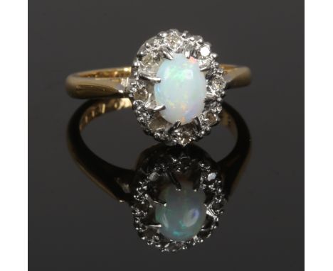 An 18ct gold opal and diamond ring, size L