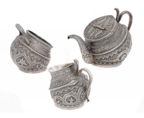 AN INDIAN SILVER REPOUSSÉ KANG TYPE 'TILTED' TEA SERVICE, KASHMIR, LATE 19TH C chased with a traditional design of leafy foli