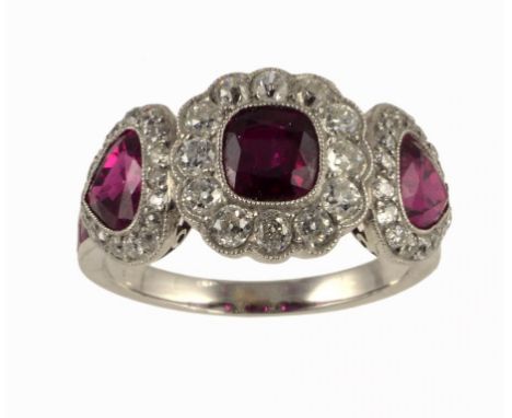 A RUBY AND DIAMOND RING of oblong and heart shaped clusters with calibre cut rubies to the shoulders, in white gold, 6.6g, si