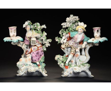 A PAIR OF DERBY CANDLESTICK FIGURES OF A SEATED SHEPHERD AND SHEPHERDESS EMBLEMATIC OF LIBERTY AND MATRIMONY, C1770  24cm h +