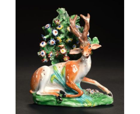 A DERBY MODEL OF A STAG AT LODGE BEFORE BOCAGE, C1800  10cm h, incised 2, painted 27 in red and 46 in yellow ++Some old resto
