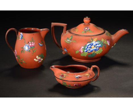 TWO WEDGWOOD  ROSSO ANTICO  CREAM JUGS, C1840 AND A MATCHING WEDGWOOD TEAPOT AND COVER, 1865  enamelled with Chinese flowers,