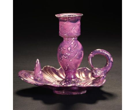 AN PURPLE MARBLED LUSTRE  DOLPHIN HANDLED CHAMBER CANDLESTICK, C1820  13cm h ++Stem restored to shell shaped base at narrowes
