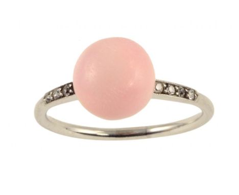 A PINK PEARL RING WITH DIAMOND SHOULDERS, C1930 the button shaped pearl of 8mm approx, 3.2g, size L Sold with The Gem & Pearl