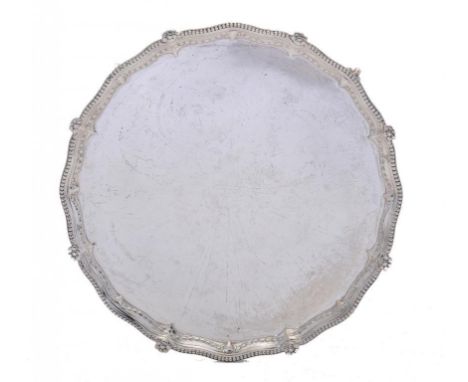 A VICTORIAN SILVER SALVER  the border embossed with rams' heads and husks, on four claw and ball feet, 31cm diam, by Thomas B