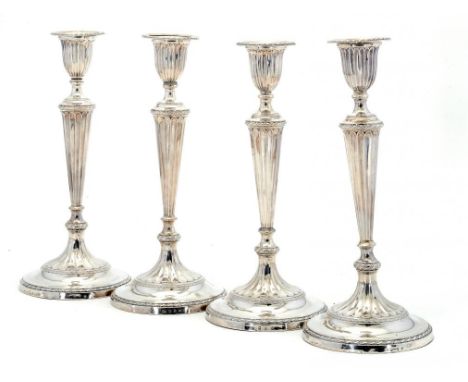 A SET OF FOUR SCOTTISH VICTORIAN SILVER NEO CLASSICAL STYLE SILVER CANDLESTICKS with nozzles, 31cm h, by Hamilton & Inches, E