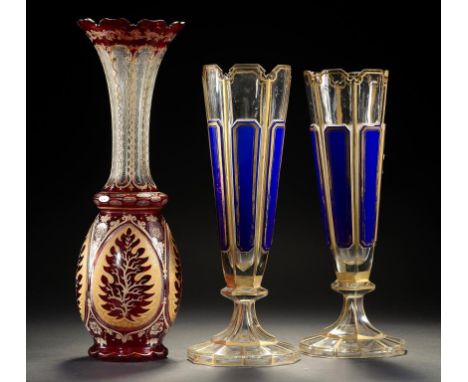 A PAIR OF FRENCH OR BOHEMIAN BLUE AND GILT OVERLAY GLASS VASES AND A RUBY FLASHED AND GILT GLASS VASE, C1870  34 and 39.4cm h