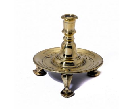 A BRASS THREE FOOTED DESK CANDLESTICK, POSSIBLY DUTCH, EARLY 18TH C  12.5cm h ++One foot slightly loose but in otherwise good