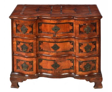 A GERMAN SERPENTINE WALNUT, OAK AND INLAID COMMODE, C1750 with steel locks and brass rococo lockplates and handles, 86cm h; 6