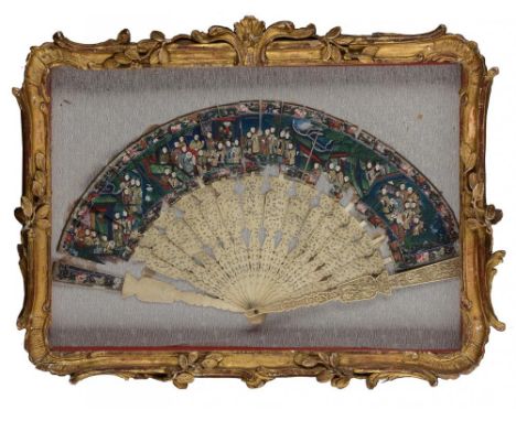 A CHINESE IVORY BRISÉ FAN, CANTON, C1830  the guards and sticks intricately carved with scenes, the leaf painted with numerou