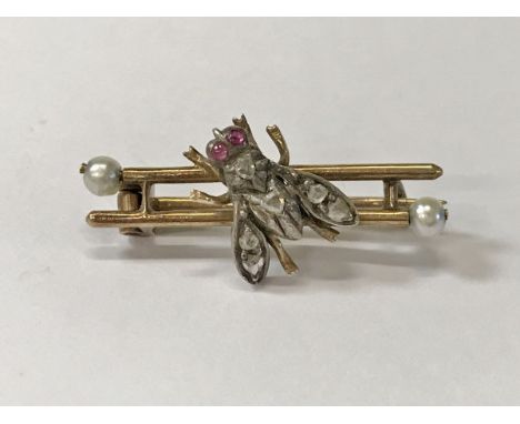 A yellow metal diamond ruby and seed pearl "Bee" brooch, 2.5 g CONDITION REPORTS Length of brooch approx 2.6cm.  Condition us