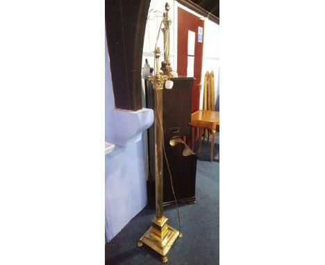 A brass standard lamp and two table lamps