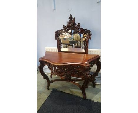 A reproduction serpentine console table and over mantel mirror