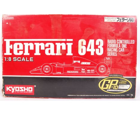 A vintage Kyosho 1:8 Ferrari 643 Formula One style remote controlled plastic racing model kit. Appears to be fully assembled,