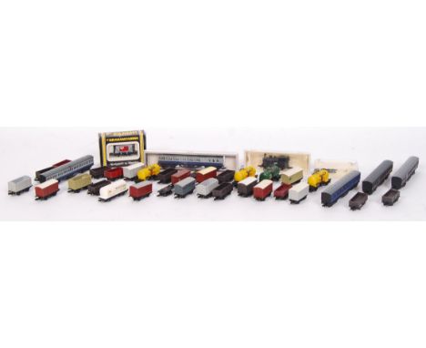 A collection of assorted vintage N gauge rolling stock - largely carriages and wagons, but some other items present. To inclu
